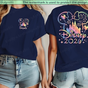 May include: Navy blue t-shirt with a colorful Disney design. The front features a castle and the name "Sophia". The back displays a Minnie Mouse bow, castle, fireworks, and the text "Disney 2026".