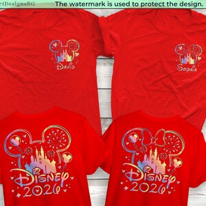 May include: Red t-shirts with Disney-themed designs. One shirt features "David" and a castle design, while the other says "Sophia." The lower shirts display "Disney 2026" with a castle and fireworks design. The designs are in iridescent colors.