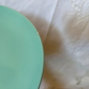 May include: A light blue ceramic bowl with a smooth, glossy finish.