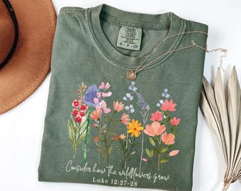 May include: A green t-shirt with a floral design and the text "Consider how the wildflowers grow. Luke 12:27-28".