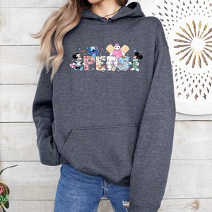 May include: A dark gray hooded sweatshirt with a colorful graphic of Disney characters spelling out the word "SUPER" on the front.