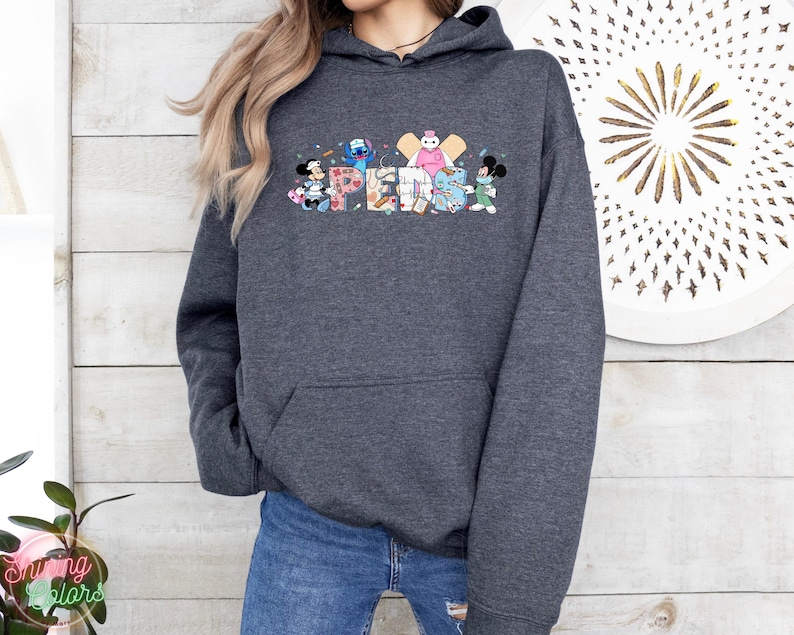 May include: A dark gray hooded sweatshirt with a colorful graphic of Disney characters spelling out the word "SUPER" on the front.
