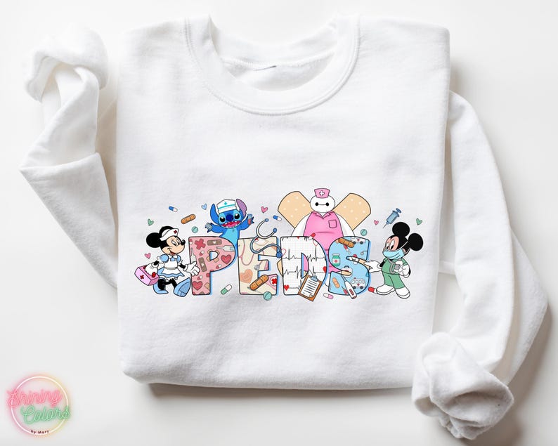 May include: White sweatshirt with a colorful graphic of cartoon characters dressed as nurses. The graphic includes Mickey Mouse, Stitch, Baymax, and the word "Peds".