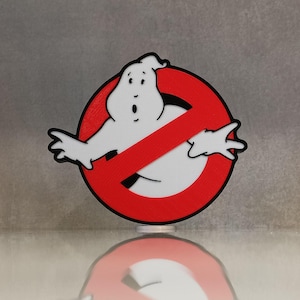May include: A red circle with a diagonal line through it, featuring a white ghost with black outlines. The ghost has a surprised expression and is reaching out with both hands. The text "No Ghost" is not visible in the image.