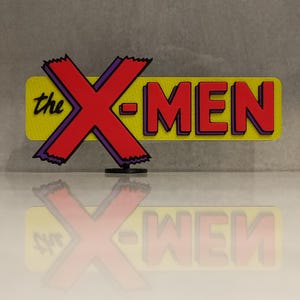 May include: A three-dimensional sign featuring the text 'the X-MEN' in a bold, comic-book style. The large 'X' is red with a purple outline, while the word 'MEN' is red with purple shadows, all set against a textured, bright yellow rectangular background.