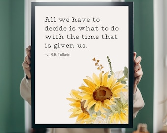 May include: A framed print with a quote by J.R.R. Tolkien: "All we have to decide is what to do with the time that is given us." The quote is surrounded by a watercolor illustration of sunflowers and white flowers.