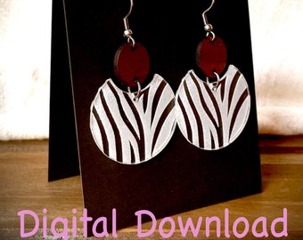May include: A pair of dangle earrings with a zebra stripe design. The earrings feature a silver hook, a small, round, dark red wooden accent, and a semi-circular, white and black zebra-striped pendant. The words "Digital Download" are at the bottom.