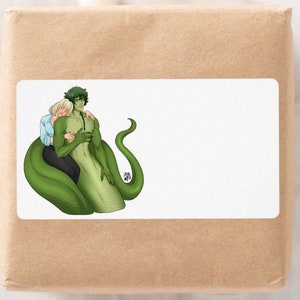 May include: A white rectangular sticker on a brown package features an illustration of two figures embracing. One figure has green skin and a snake tail, while the other has fair skin and blonde hair. The figures are embracing each other.
