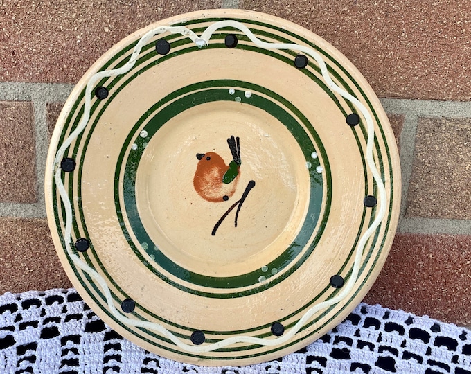 A pair of hand-painted collectible hanging plates from the 50s