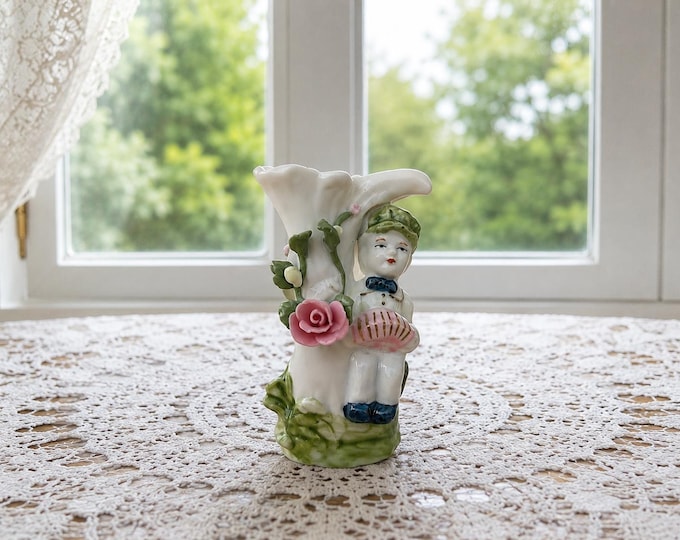 Miniature figurine with pink rose.