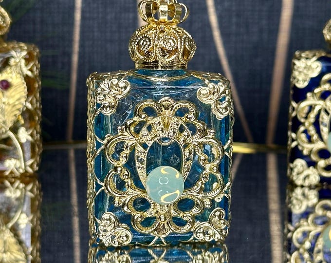 Elegant Light Blue Glass Oil Perfume Bottle with Gold Ornament and Uranium Glass Cabochon