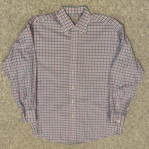 May include: A long-sleeve button-down shirt featuring a small-scale checkered pattern in shades of pink, dark green, and white. The shirt includes a standard collar, a full-length front button placket, and buttoned cuffs on the long sleeves.