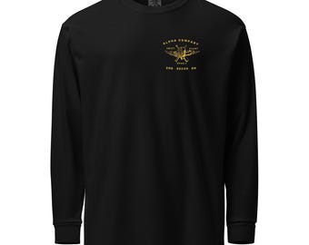 May include: Black long-sleeve shirt with a crew neck. The shirt features a gold graphic on the upper left chest that reads "ALPHA COMPANY SWIFT SILENT DEADLY 2ND RECON BN".
