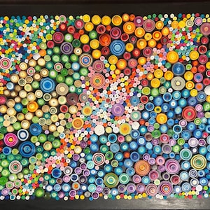 May include: A colorful abstract art piece made of paper circles of various sizes and colors. The circles are arranged in a swirling pattern on a black background.