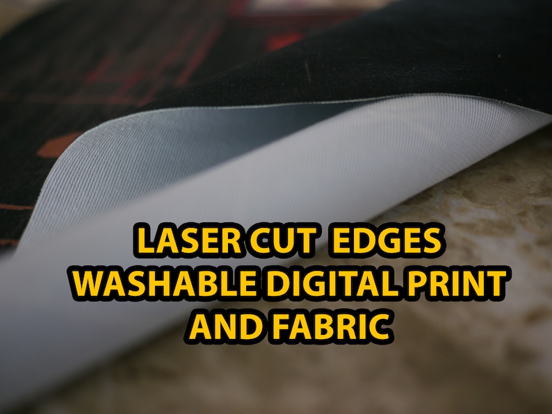 May include: Close-up of a white fabric with a laser-cut edge. The fabric has a digital print and the text "LASER CUT EDGES WASHABLE DIGITAL PRINT AND FABRIC" is printed in yellow.