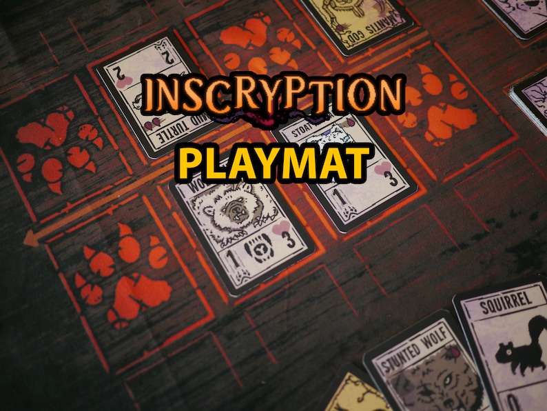 May include: A brown and black Inscryption playmat with red paw prints and game cards featuring illustrations of animals and numbers. The text "Inscryption Playmat" is printed in yellow on the mat.