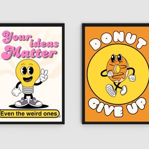 May include: Two framed retro-style art prints. One features a cartoon lightbulb with the text "Your ideas Matter" and "Even the weird ones." The other shows a cartoon donut with the text "Donut Give Up" on an orange background.