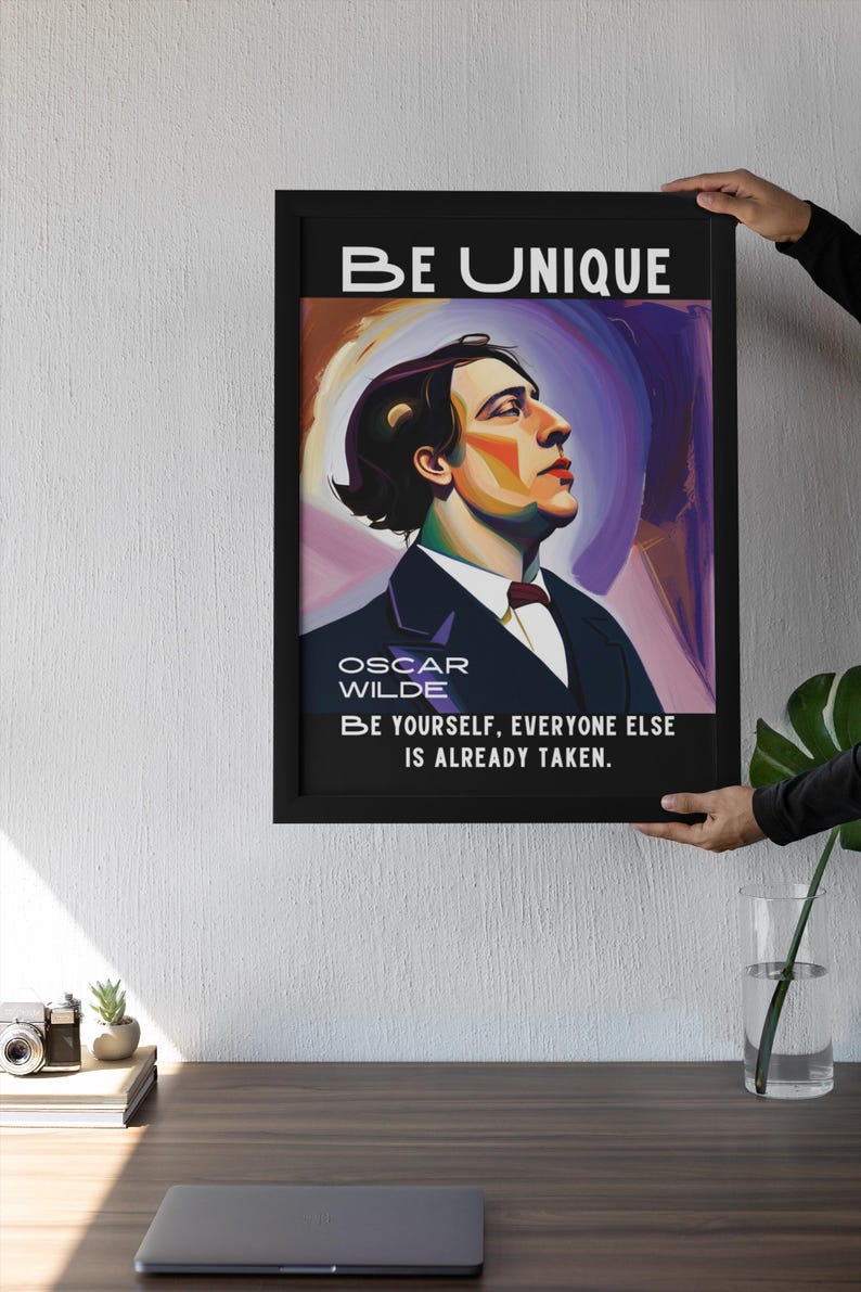 May include: Black framed art print featuring a portrait of Oscar Wilde with the text "BE UNIQUE" at the top. The print includes the quote "BE YOURSELF, EVERYONE ELSE IS ALREADY TAKEN."