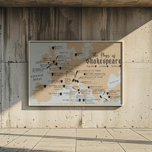 May include: A beige map with black text and arrows showing the locations of Shakespeare's plays. The map is titled "The Plays of Shakespeare" and includes a list of the plays. The map is framed and hanging on a concrete wall.