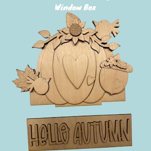 May include: DIY insert for an interchangeable window box featuring a pumpkin with a heart, birds, leaves, and a sunflower. The insert also includes a separate sign that reads "Hello Autumn".
