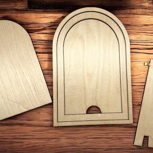May include: Three unfinished wooden pieces for a DIY picture frame. The frame is made of two arched pieces and a stand. The stand has two small square pieces attached to it.