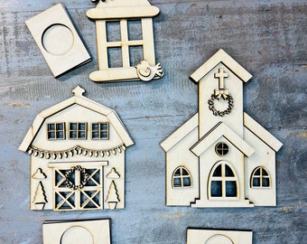 May include: Five unfinished wooden Christmas ornaments, including a church, a barn, a lantern, and two blank circles. The ornaments are all made of light brown wood and have intricate details.