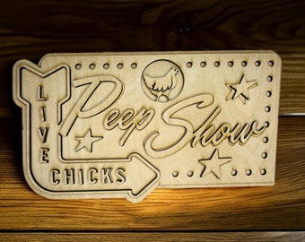 May include: A wooden sign with the text "Live Peep Show Chicks" and a cartoon chicken. The sign has a dotted border and stars.
