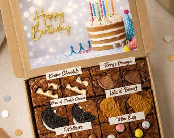 May include: A cardboard gift box containing twelve brownies topped with various treats, including Kinder Chocolate, Terry's Orange, Oreo & Cookie Cream, Lotus Biscoff, and Mini Eggs. The lid features a Happy Birthday graphic with a cake illustration.