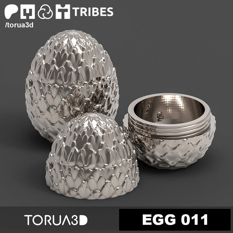 May include: A silver dragon egg-shaped box with a textured surface. The box is open, revealing a silver interior. The box is labeled "EGG 011".