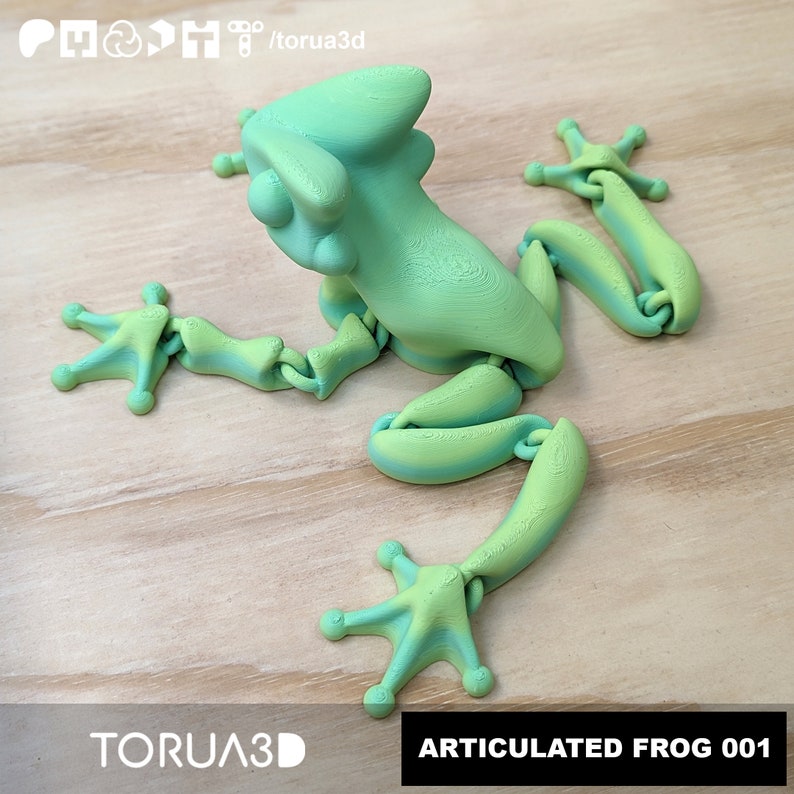May include: A green and yellow articulated frog figurine with movable limbs. The frog is posed with its legs outstretched and its head tilted to the side. The figurine is made of plastic and has a smooth, glossy finish.