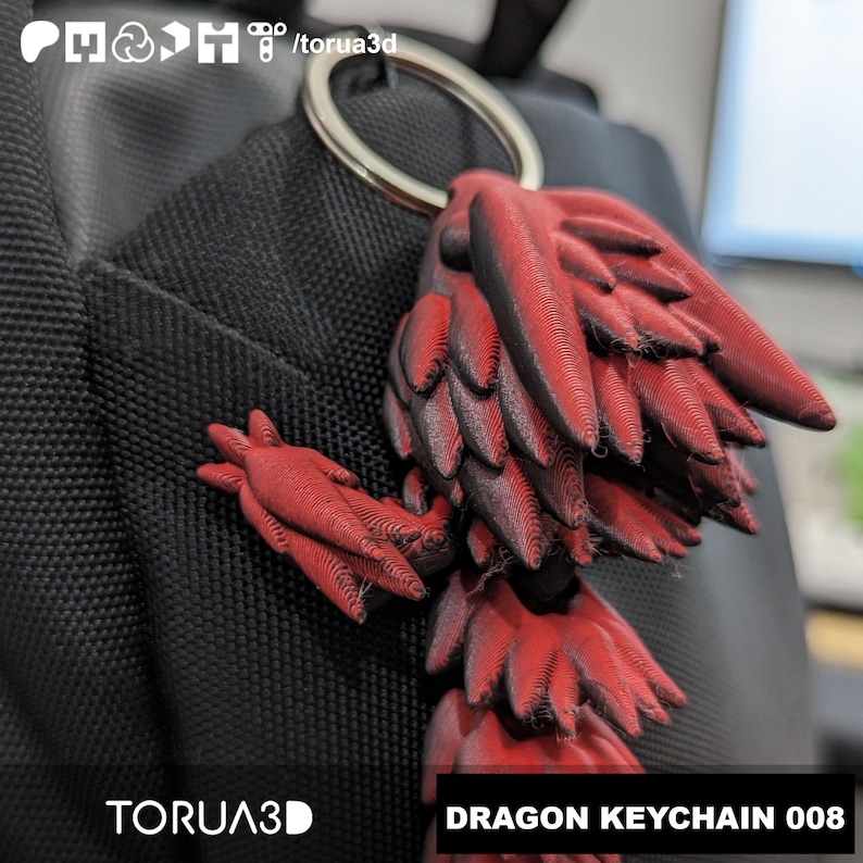 May include: Red and black dragon keychain with a silver keyring. The dragon has detailed wing and body features. The text "DRAGON KEYCHAIN 008" is displayed on the bottom right.