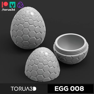 May include: A 3D printed white egg-shaped container with a hexagonal pattern. The egg is open and the inside is visible. The egg is labeled "EGG 008" and "TORUA3D".