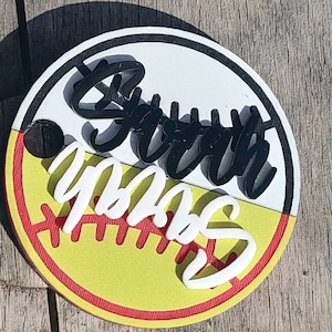 May include: A round, yellow and white softball with red stitching. The words "Softball" and "YPAS" are written on the ball in black and white.