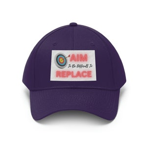 May include: Purple baseball cap with a white patch featuring a red and white target with an arrow and the text "AIM To Be Difficult To REPLACE".