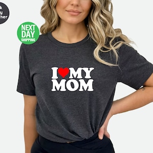 May include: A dark heather grey t-shirt with a white graphic that says "I love my MOM" with a red heart.