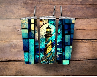 May include: Three stainless steel tumblers with a stained glass design featuring a lighthouse in a stormy sea. The design is in shades of blue, green, and yellow.