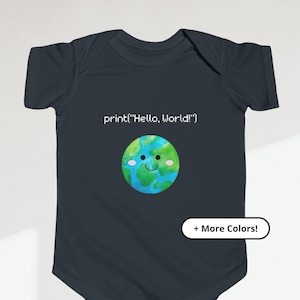 May include: A dark blue baby onesie with a smiling cartoon earth and the text "print('Hello, World!')". The onesie has a white button closure and a white tag that says "More Colors!"