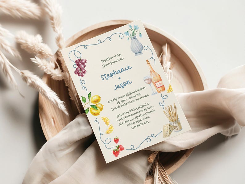 a wedding invitation card with a decorative border and various illustrations, including grapes, a vase, and other food items.