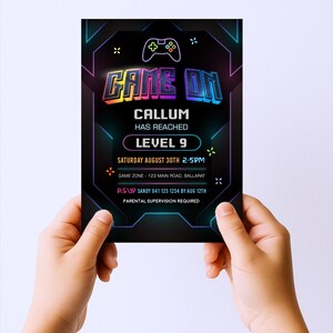 a person holding up a card for a game on