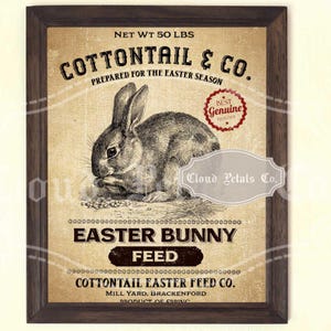 May include: A framed vintage-style print featuring a detailed illustration of a rabbit. The print includes text that reads "COTTONTAIL & CO." and "EASTER BUNNY FEED." The frame is dark brown, and the background has a textured, aged appearance. The net weight is 50 lbs.