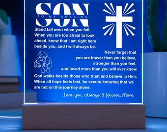 May include: A blue LED night light with the word "SON" in white, along with a cross and a message from "Mom." The light sits on a wooden base. The text includes inspirational quotes.