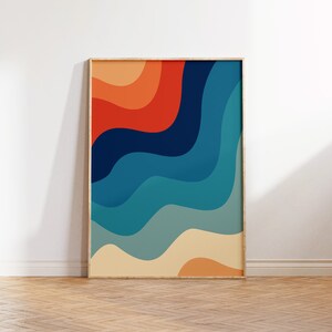 May include: Abstract wall art print with a retro design featuring wavy lines in shades of orange, red, blue, and green. The print is framed in a natural wood frame.