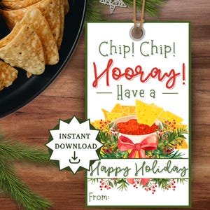 May include: A festive gift tag with the words "Chip! Chip! Hooray! Have a Happy Holiday" in red and green. The tag features a watercolor illustration of tortilla chips and salsa, with a red bow. A plate of chips and dip is in the background.