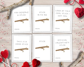 May include: Six white Valentine's Day cards with stick illustrations and phrases like "You Deserve a Stick" and "Stick With Me." The cards are surrounded by red hearts and wooden accents.