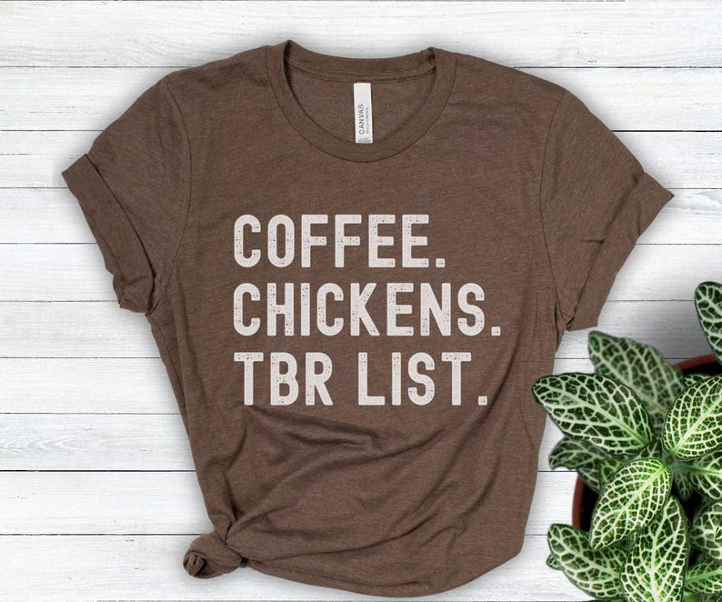 May include: A brown t-shirt with the text "COFFEE. CHICKENS. TBR LIST." printed in white.