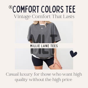 May include: A charcoal gray short-sleeve t-shirt worn over a white undershirt, paired with black athletic shorts. The image includes the text COMFORT COLORS TEE, Vintage Comfort That Lasts, MILLIE LANE TEES, and Casual luxury for those who want high quality without the high price.