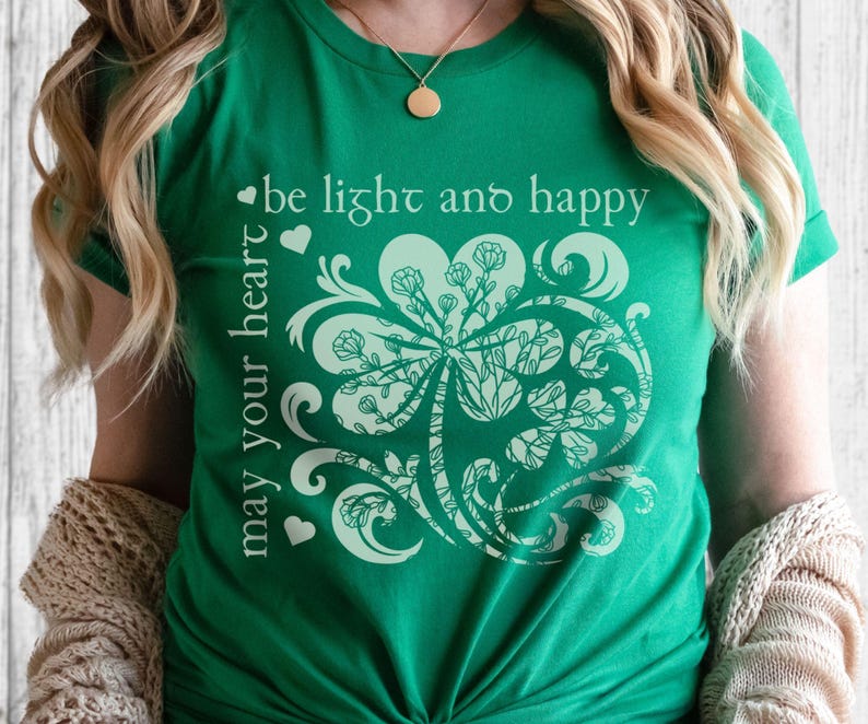 May include: Green t-shirt with a white shamrock design and the text "may your heart be light and happy".