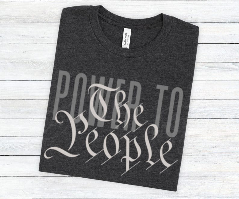 May include: A dark heather grey t-shirt with the text "Power to the People" printed in white on the front.