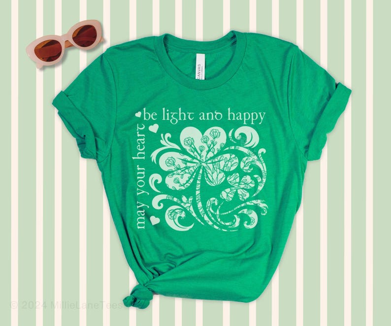 May include: Green t-shirt with a white shamrock design and the text "may your heart be light and happy".