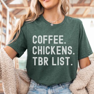 May include: A green t-shirt with the text "COFFEE. CHICKENS. TBR LIST." in white lettering.